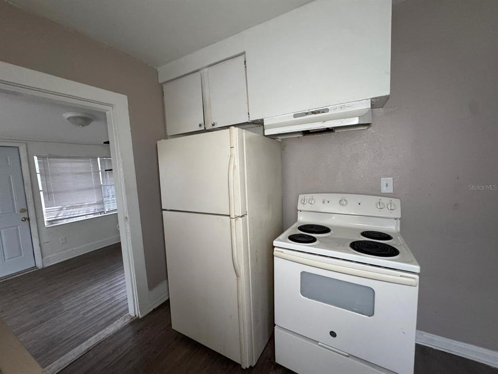 4201 Cepeda Street Orlando, FL 32811 - Photo 15 of 17 a white refrigerator freezer and a stove sitting inside of a kitchen