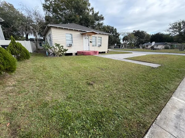 a view of a house with a yard and sitting area
