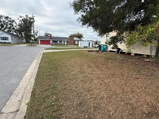 a view of outdoor space with playground and green space