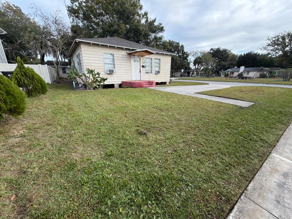 4201 Cepeda Street Orlando, FL 32811 - Photo 3 of 17 a view of a house with a yard and sitting area
