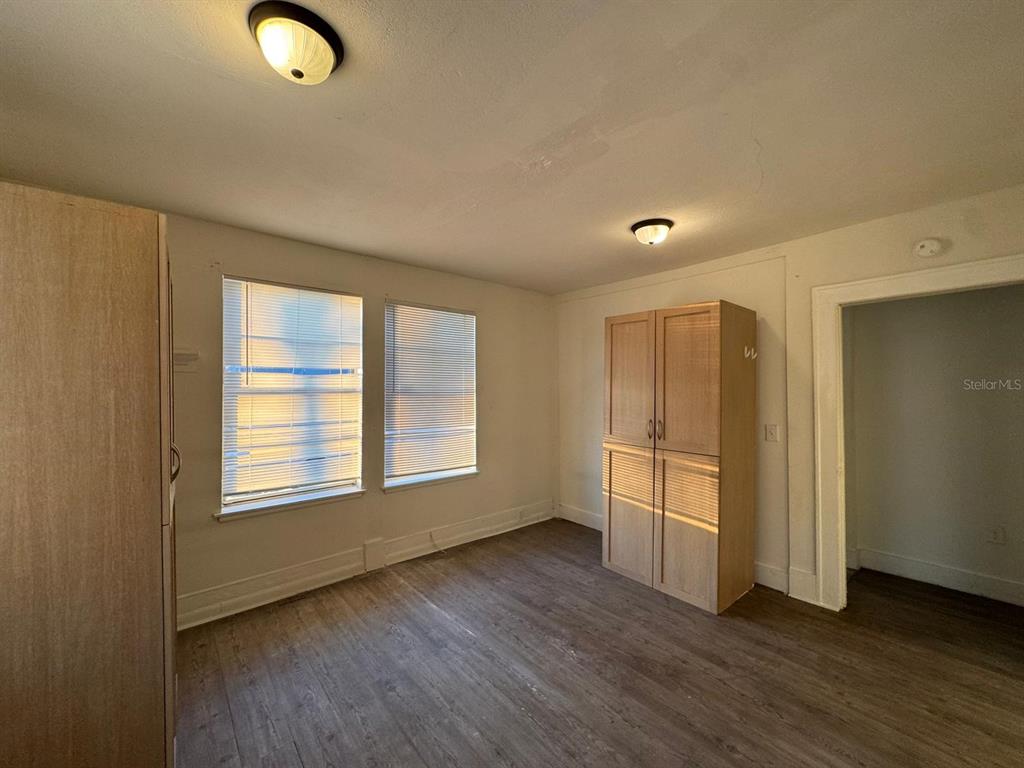 4201 Cepeda Street Orlando, FL 32811 - Photo 7 of 17 a view of an empty room with wooden floor and a window