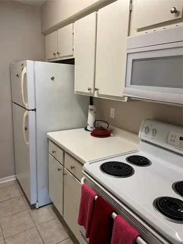 a kitchen with a refrigerator and a sink