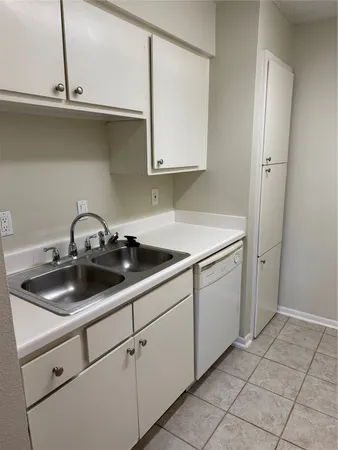 a kitchen with a sink and cabinets