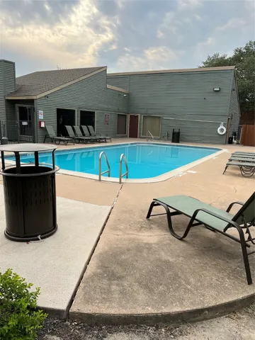 a view of a swimming pool with a lounge chair