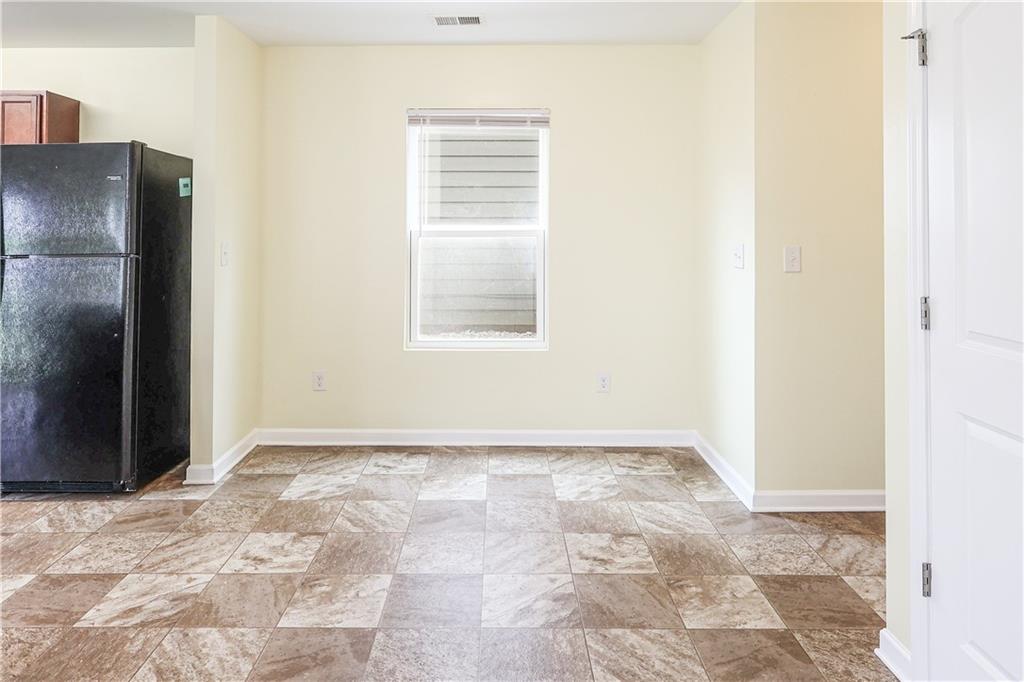 1562 Onalee Drive Hampton, GA 30228 - Photo 11 of 22 a view of an empty room with kitchen and a window