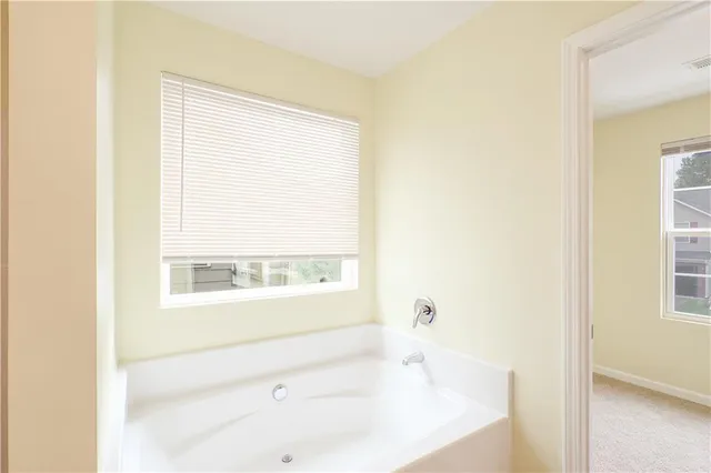 a view of a small space with wooden floor and a window
