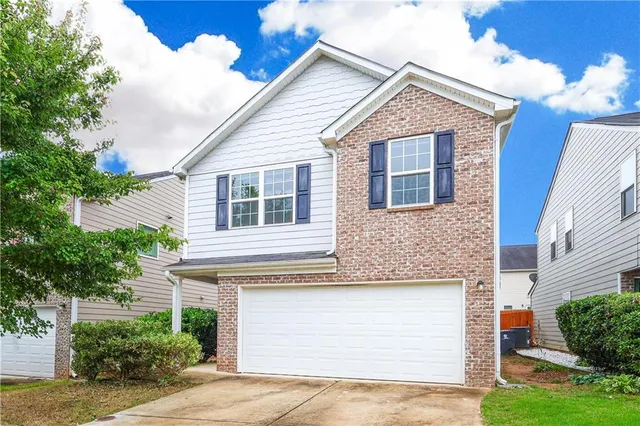 a view of a house with a yard and plants