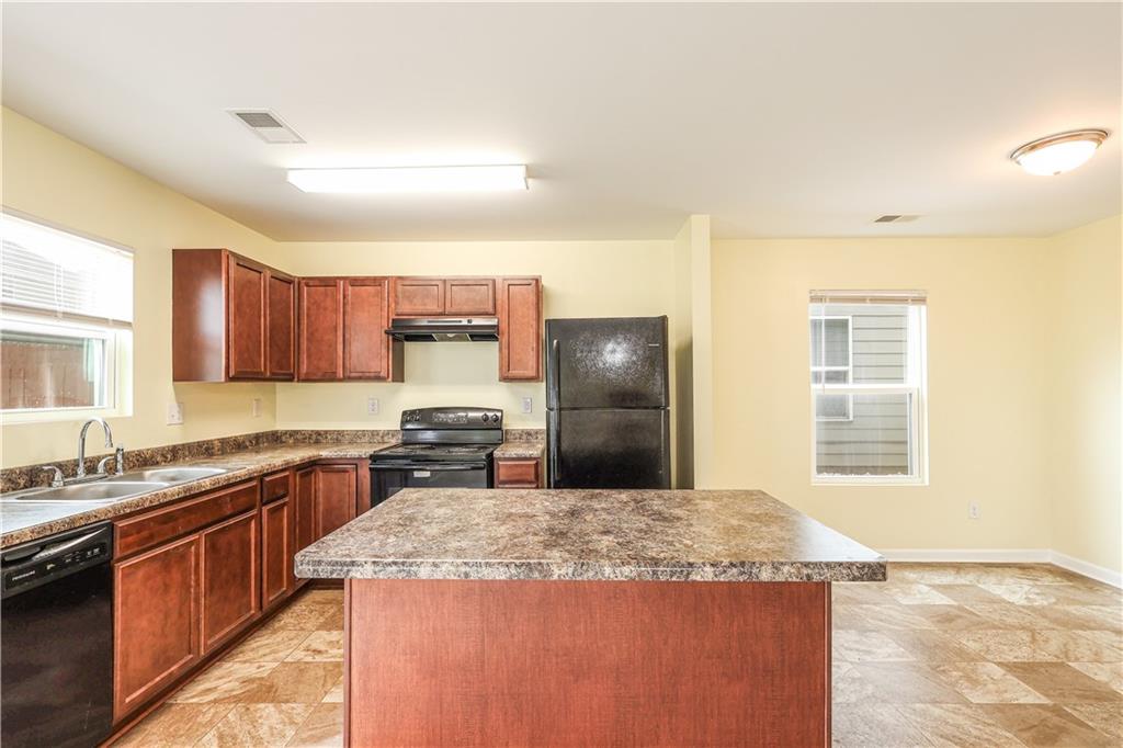 1562 Onalee Drive Hampton, GA 30228 - Photo 8 of 22 a kitchen with kitchen island granite countertop a sink stove and refrigerator