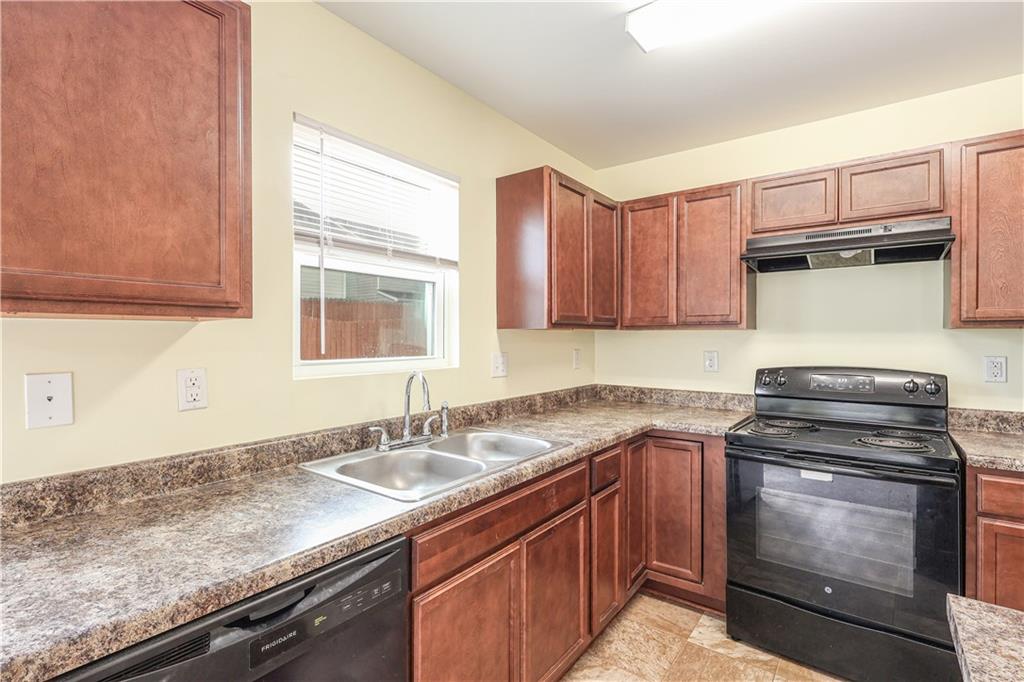 1562 Onalee Drive Hampton, GA 30228 - Photo 9 of 22 a kitchen with granite countertop a sink stove and cabinets
