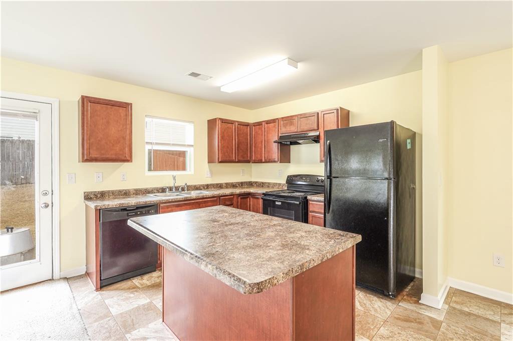 1562 Onalee Drive Hampton, GA 30228 - Photo 10 of 22 a kitchen with stainless steel appliances granite countertop a sink stove and refrigerator