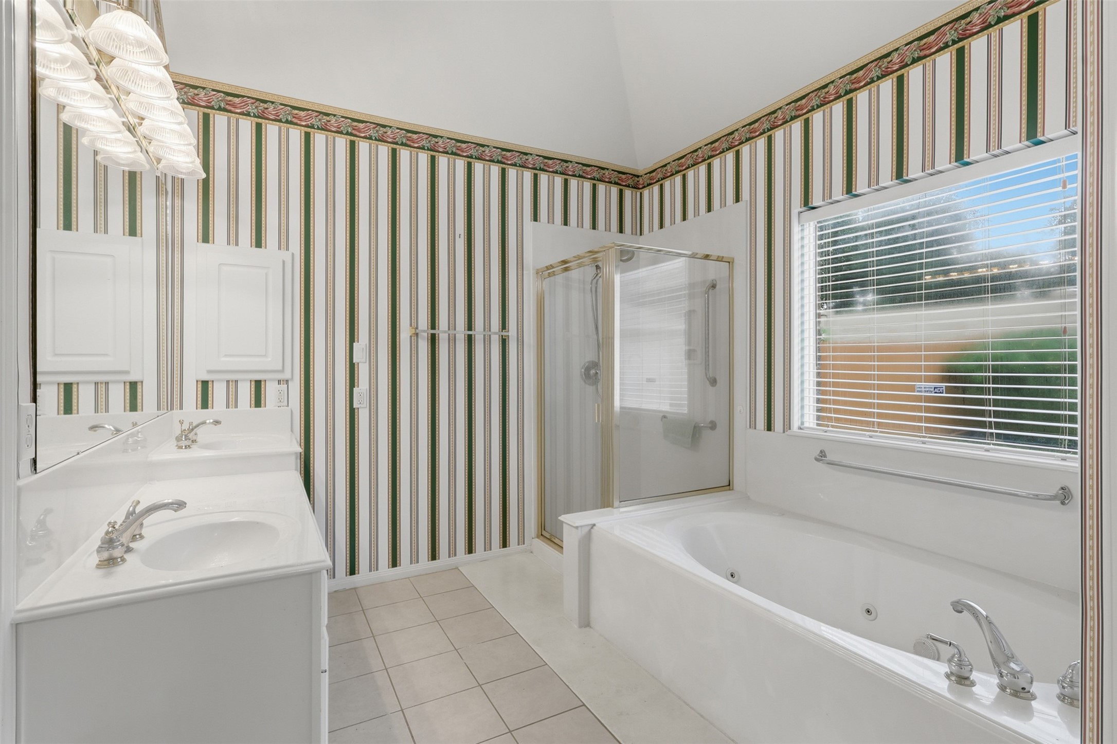 5815 Pheasant Ridge Lane Houston, TX 77041 - Photo 31 of 43 Indulge in the luxurious primary suite bathroom featuring soaring ceilings, a deep whirlpool tub to soak away the stresses of the day, an elegant design, and so much more!