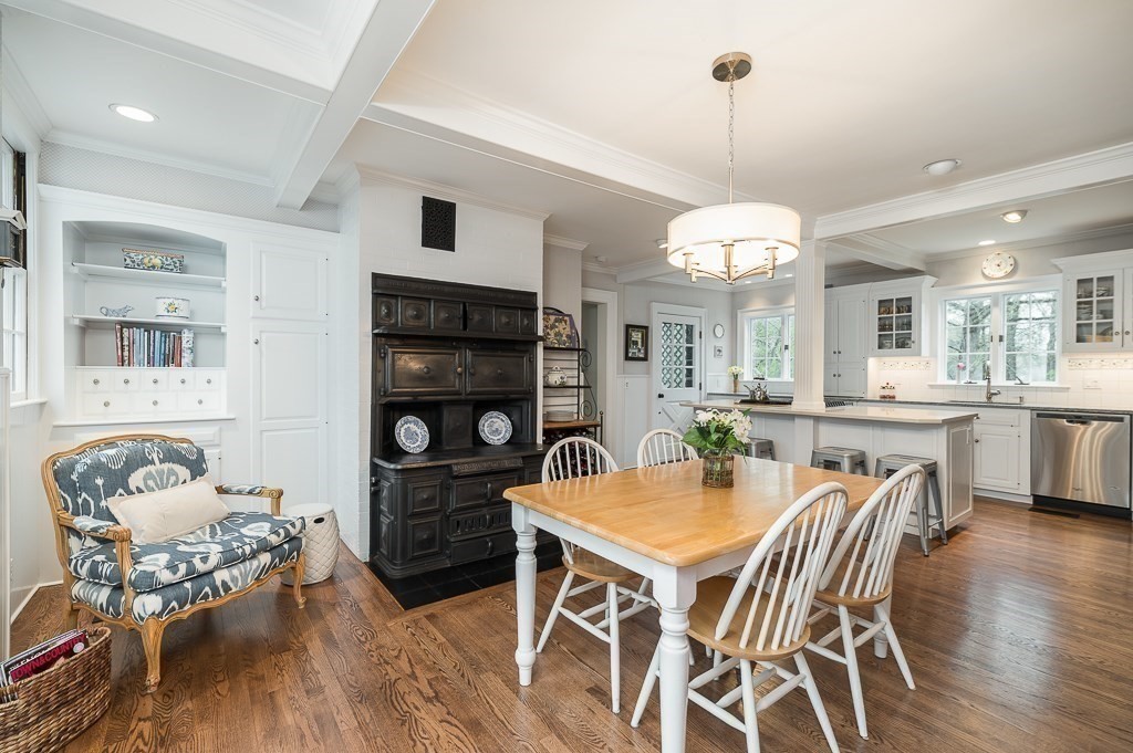 6 Jersey Lane Manchester, MA 01944 - Photo 18 of 42 a dining room with wooden floor a chandelier a wooden table and chairs