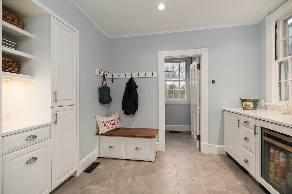 6 Jersey Lane Manchester, MA 01944 - Photo 19 of 42 a hallway with cabinets and a wooden floor