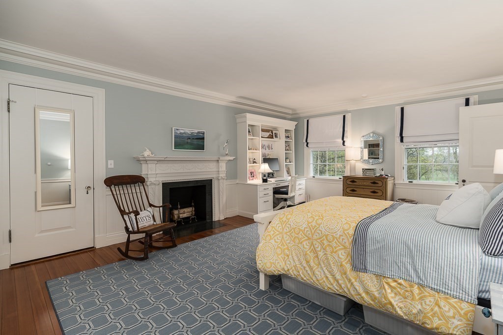 6 Jersey Lane Manchester, MA 01944 - Photo 31 of 42 a spacious bedroom with a bed chairs and a fireplace
