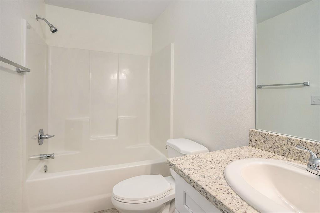 405 North Cleburne Whitney Road Rio Vista, TX 76093 - Photo 19 of 23 White shower-over-tub combination with chrome fixtures