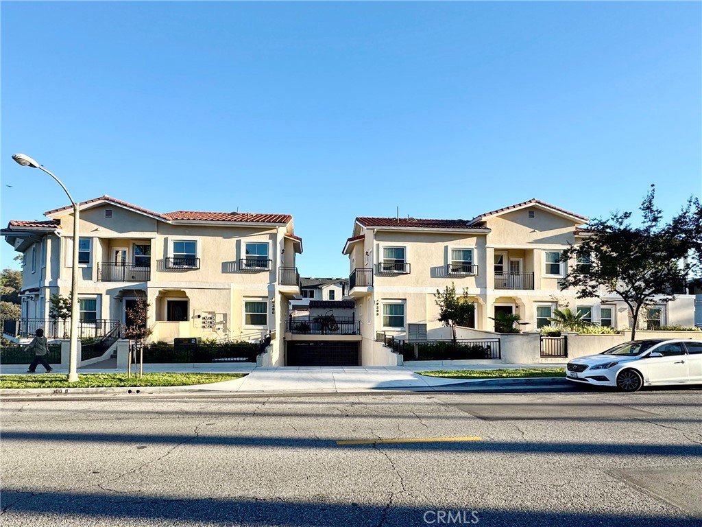 300 East Alhambra Road, Unit A Alhambra, CA 91801 - Photo 1 of 1 a view of a white house with large windows and a small yard