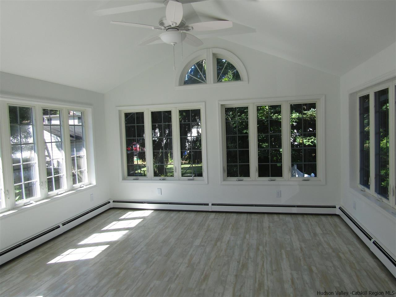 1023 Codwise Street Kingston, NY 12401 - Photo 11 of 17 a view of an empty room with wooden floor and a window