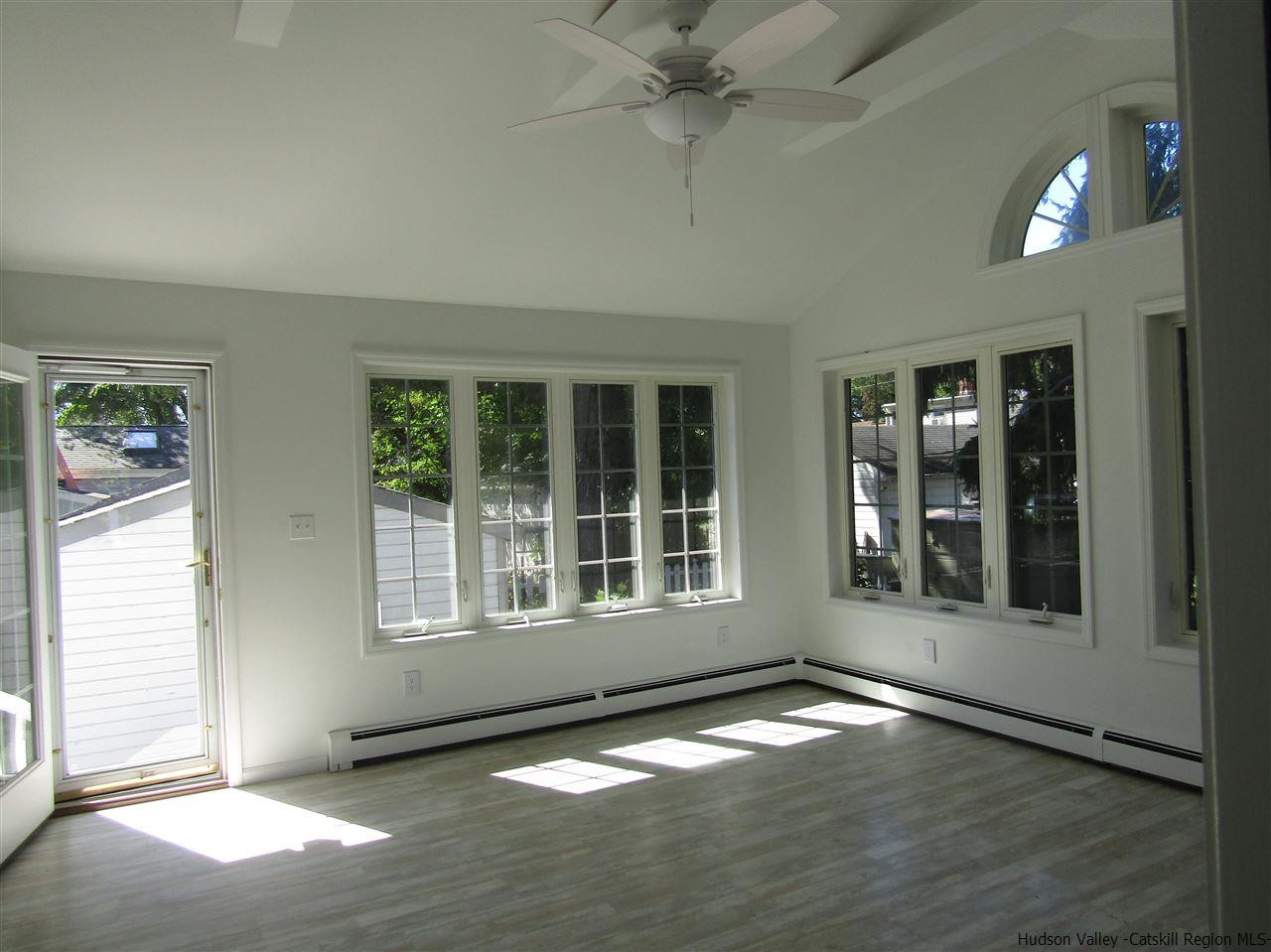 1023 Codwise Street Kingston, NY 12401 - Photo 12 of 17 an empty room with wooden floor and windows
