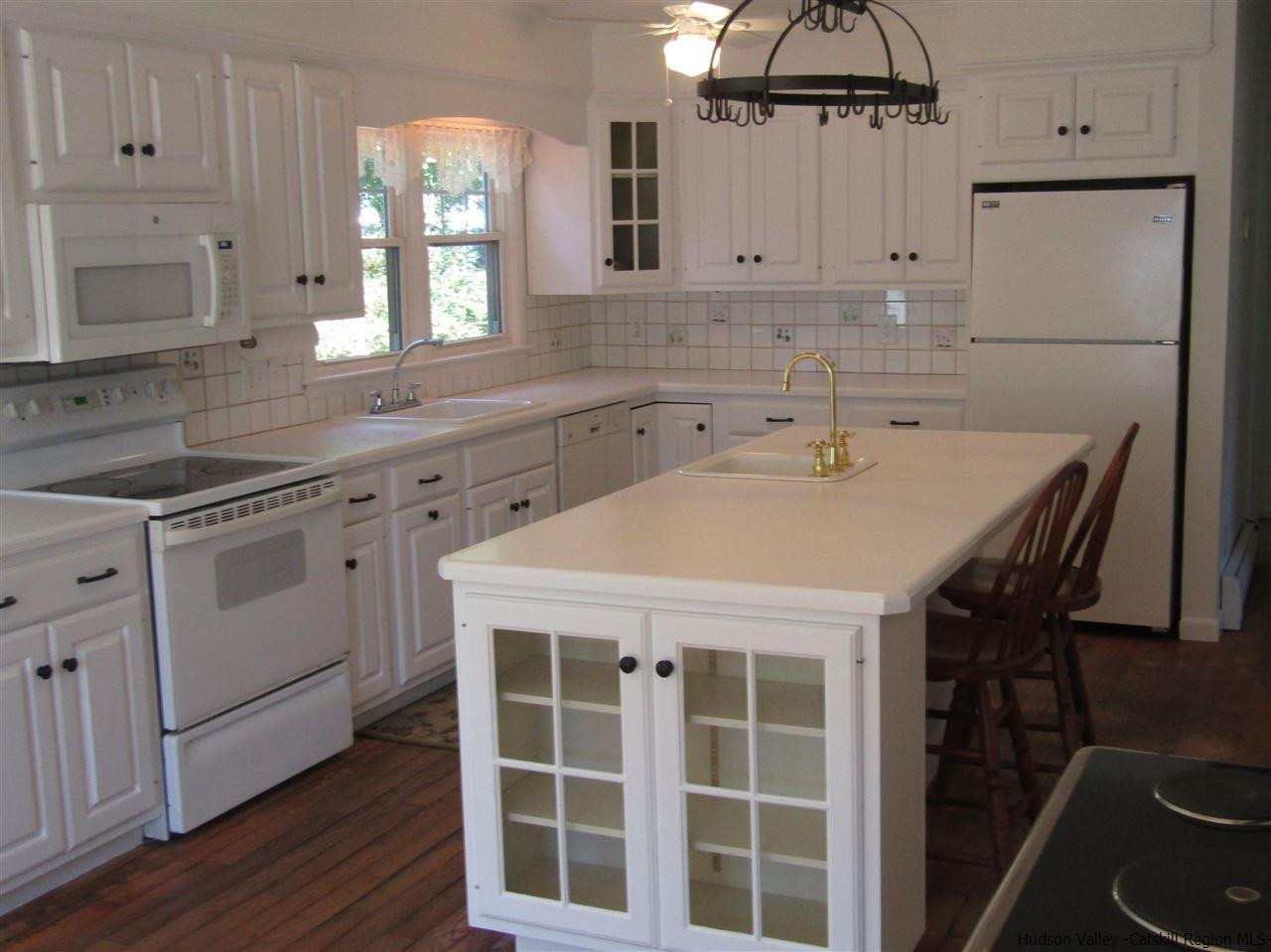 1023 Codwise Street Kingston, NY 12401 - Photo 6 of 17 a kitchen with cabinets appliances and a window