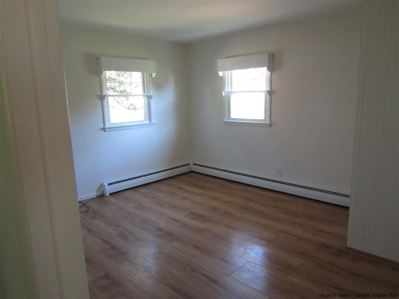 1023 Codwise Street Kingston, NY 12401 - Photo 7 of 17 an empty room with wooden floor and windows
