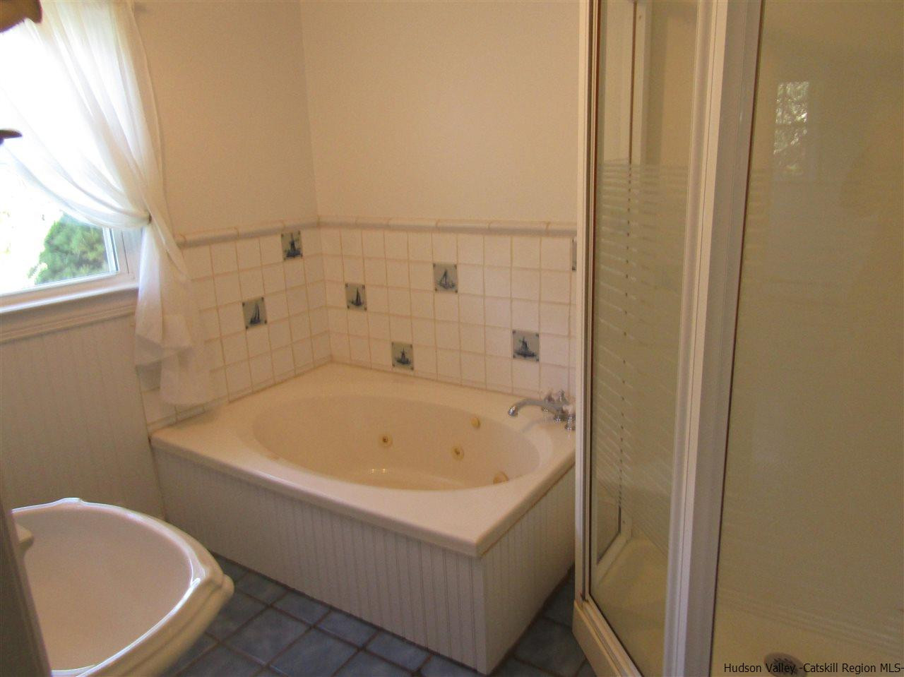 1023 Codwise Street Kingston, NY 12401 - Photo 10 of 17 a bathroom with a bathtub and window