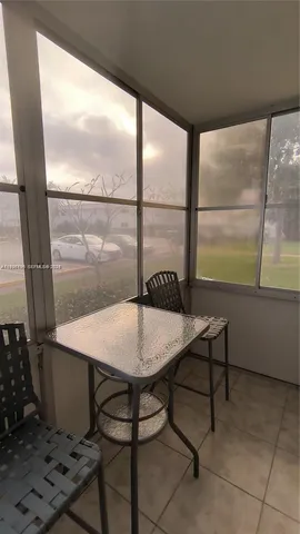 a view of a room with a table and chairs