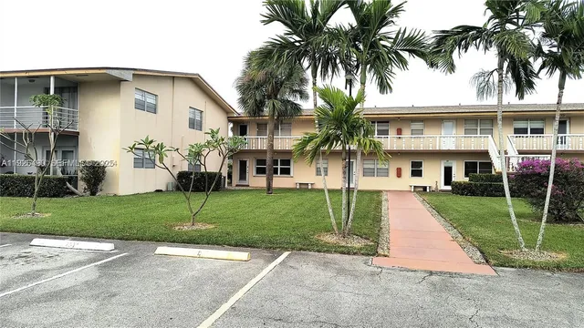a front view of a house with a garden and yard