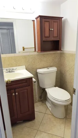 a bathroom with a toilet a sink and a window