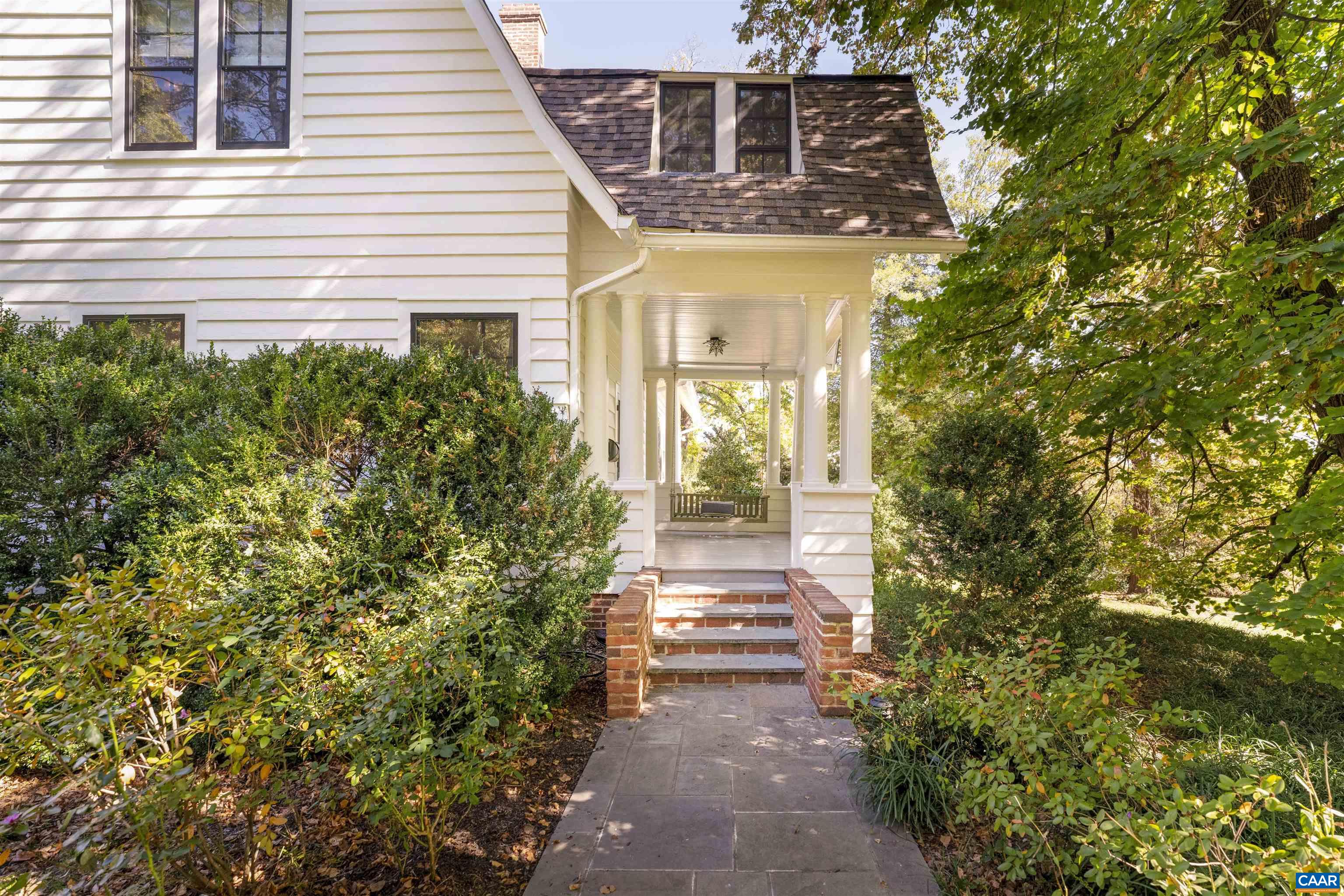 a view of a pathway of a house with potted plants