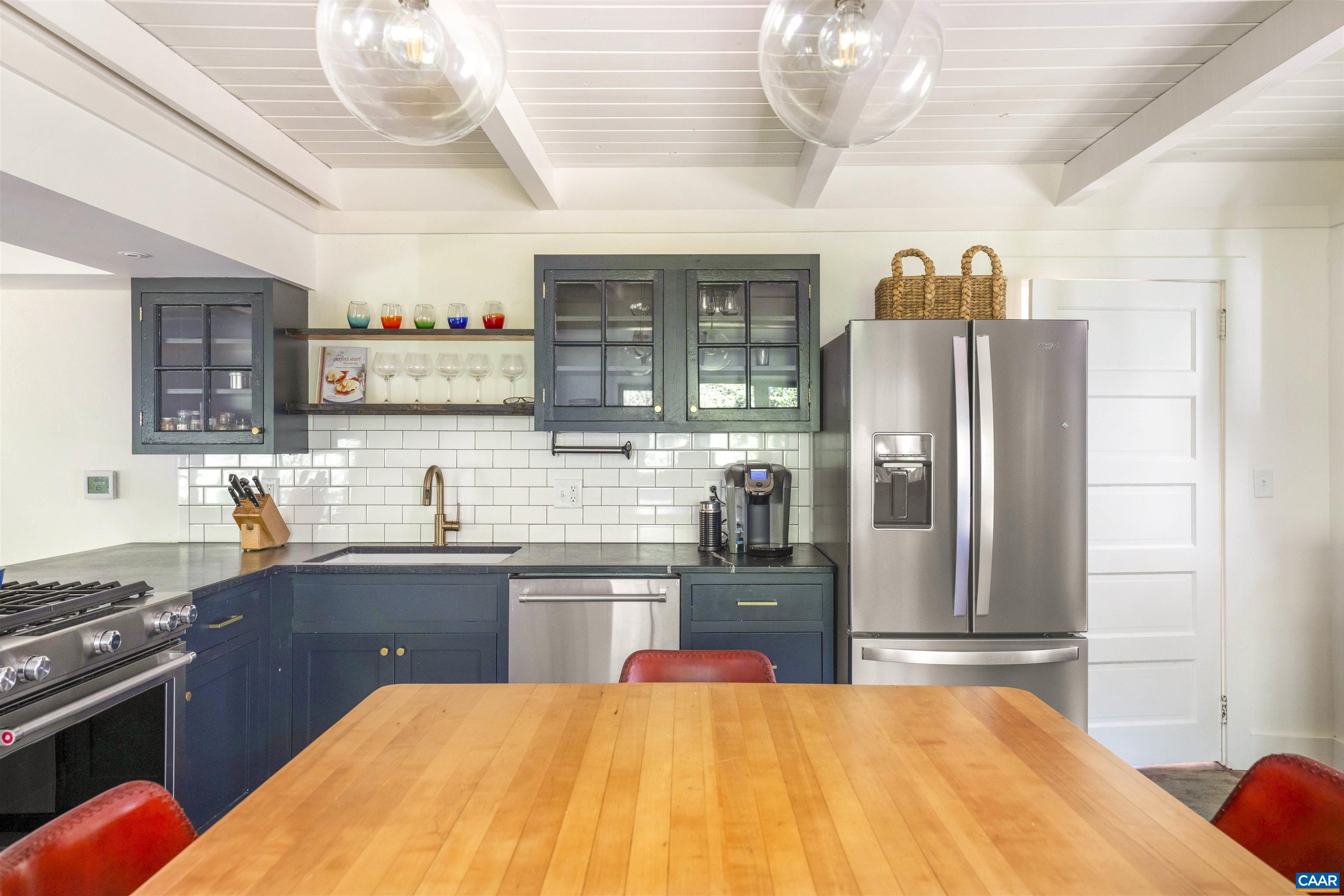 1535 Dairy Road Charlottesville, VA 22903 - Photo 51 of 70 a kitchen with stainless steel appliances kitchen island granite countertop a sink cabinets and refrigerator
