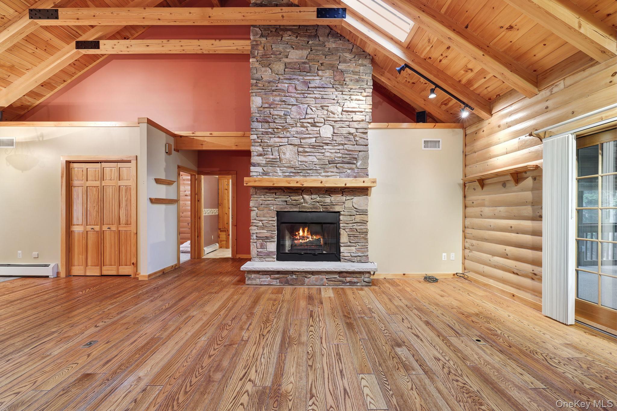 230 Post Road Slate Hill, NY 10973 - Photo 3 of 26 The living room has a stone fireplace and cathedral ceilings.