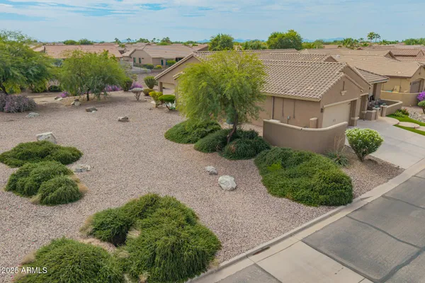 an aerial view of a house with a yard and a garage