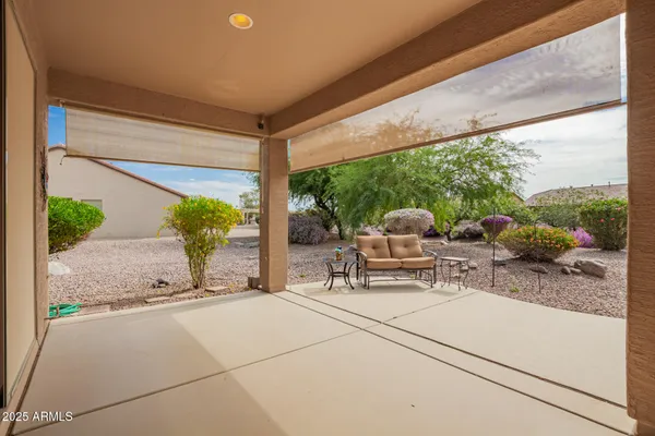 a view of a swimming pool with a yard and plants