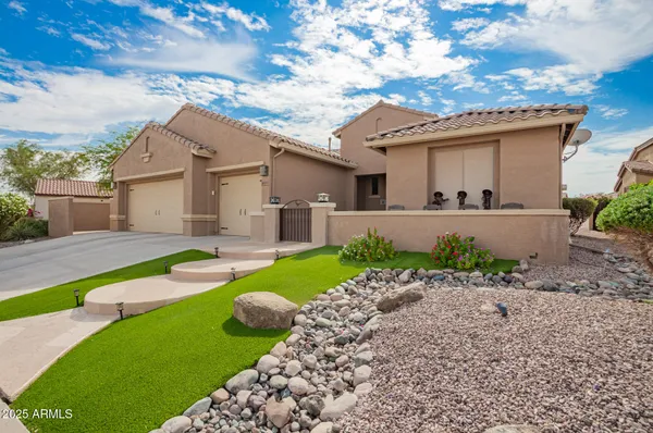 a kitchen with stainless steel appliances kitchen island granite countertop a stove top oven a sink a counter top space and cabinets