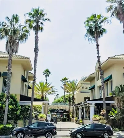 a view of multiple houses with palm trees