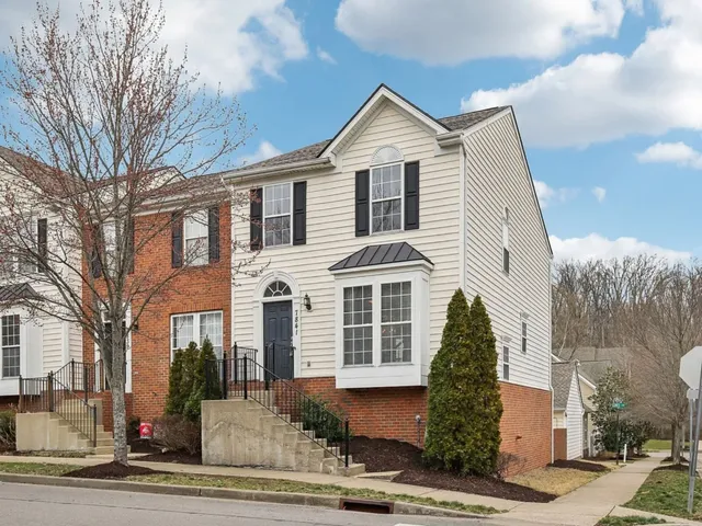a front view of a house with a road