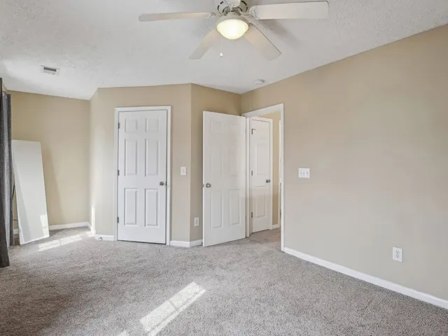 a view of a livingroom with a chandelier fan