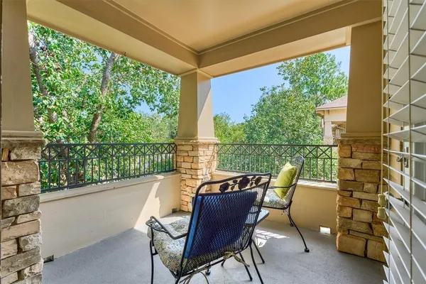 a view of a chair and table in the balcony