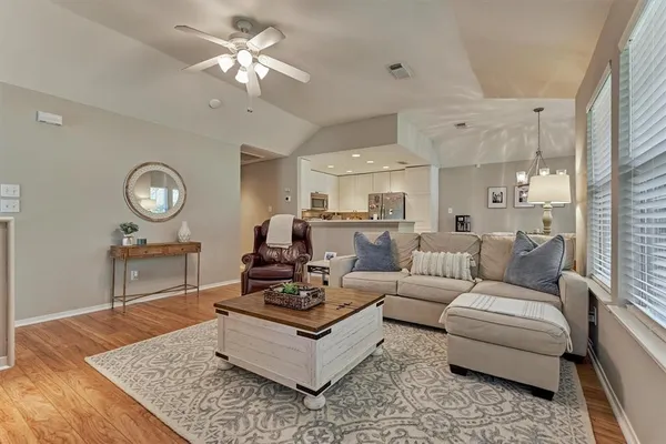 a living room with furniture a clock and a chandelier