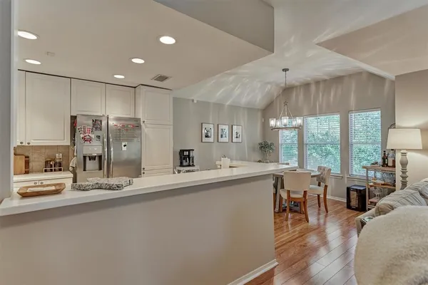 a kitchen with stainless steel appliances granite countertop a sink refrigerator and cabinets