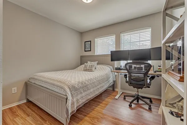 a bedroom with a bed and a desk