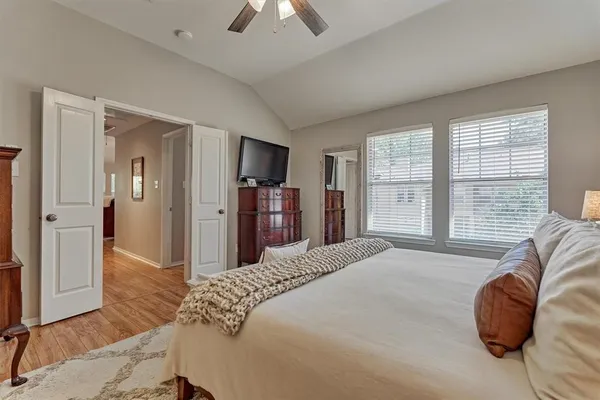 a bedroom with a bed and a large mirror