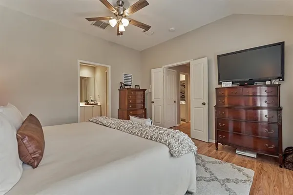 a bedroom with a bed and a flat screen tv