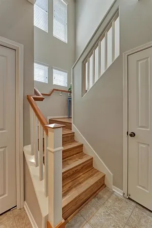a view of staircase with railing and white walls
