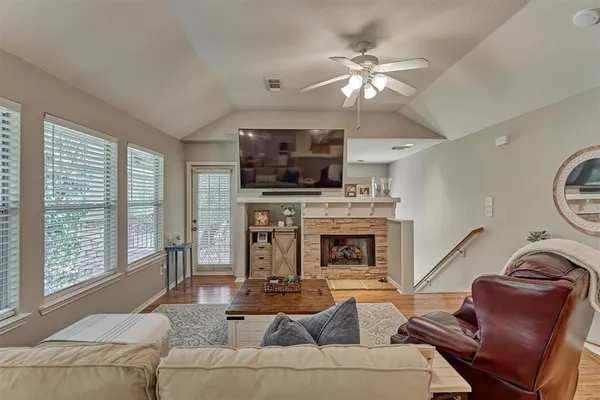 a living room with furniture a fireplace and a flat screen tv