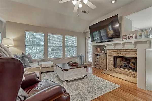 a living room with furniture a flat screen tv and a fireplace