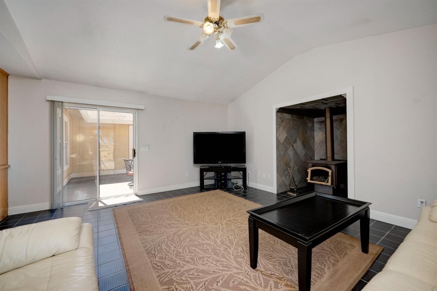 4427 East Catlett Road Lincoln, CA 95648 - Photo 17 of 51 a living room with furniture and a flat screen tv