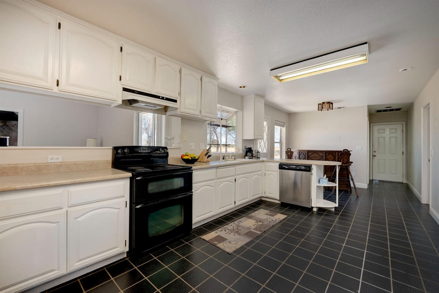 4427 East Catlett Road Lincoln, CA 95648 - Photo 20 of 51 a kitchen with granite countertop a sink cabinets and stainless steel appliances