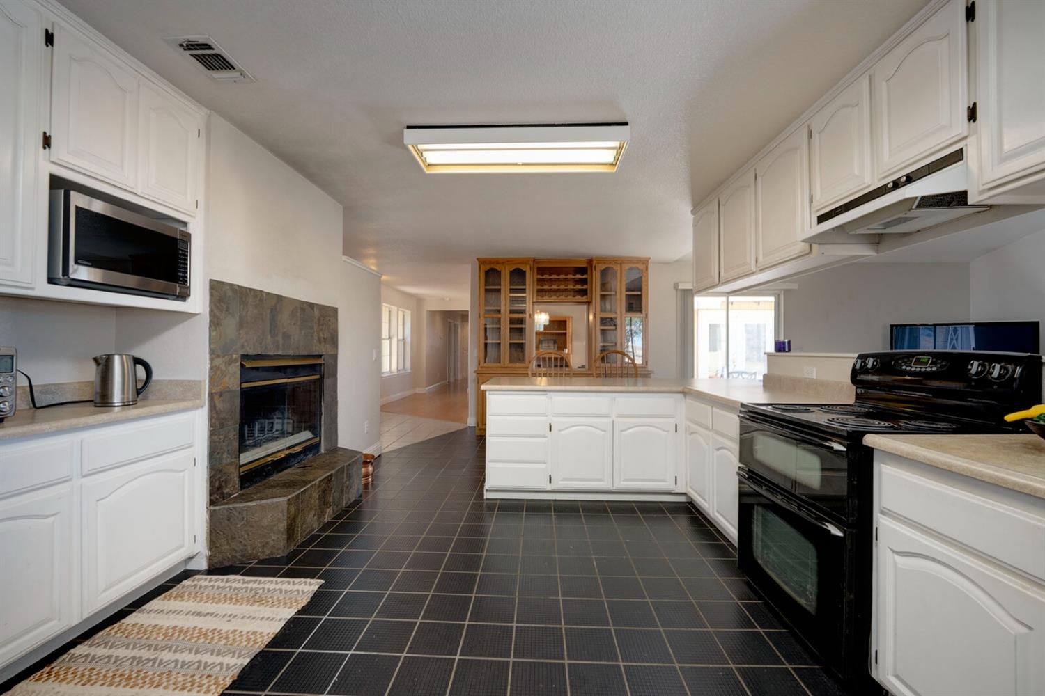 4427 East Catlett Road Lincoln, CA 95648 - Photo 21 of 51 a kitchen with a stove top oven and cabinets