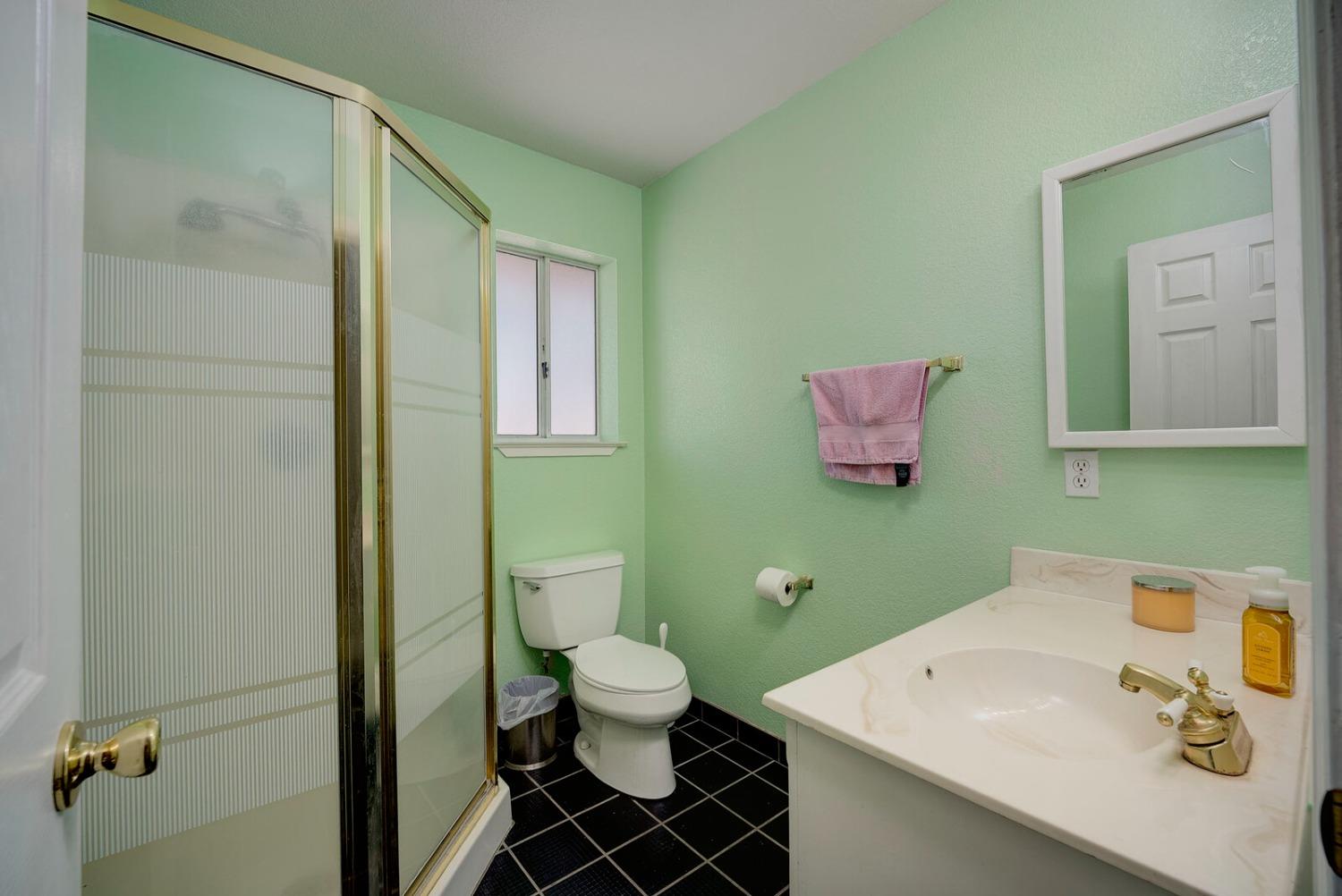 4427 East Catlett Road Lincoln, CA 95648 - Photo 26 of 51 a bathroom with a sink mirror vanity and toilet
